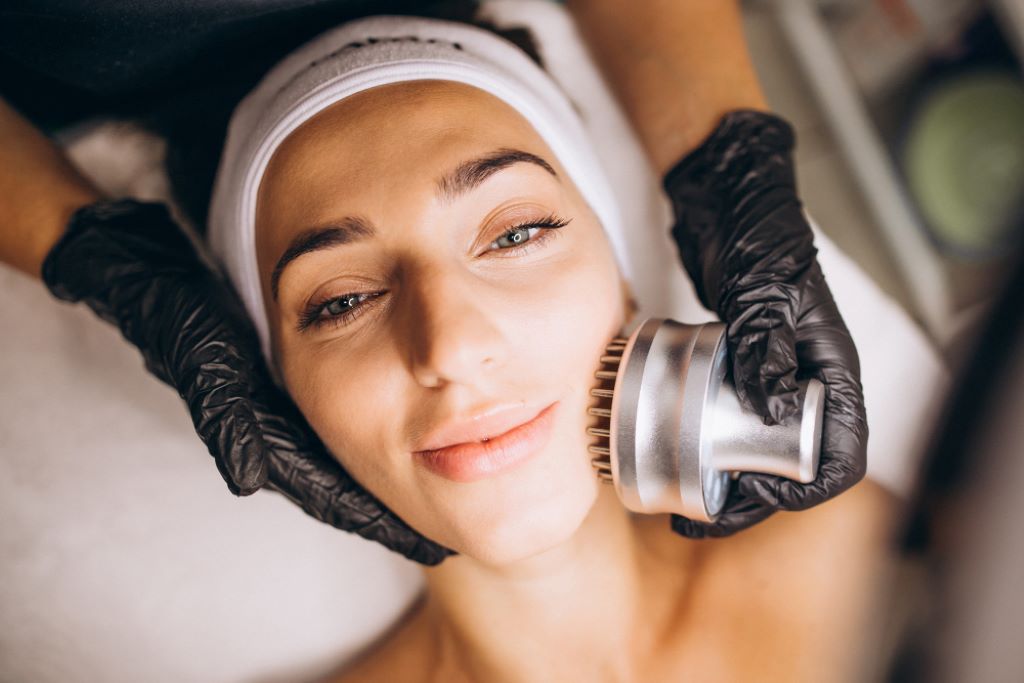 Facial treatment with electric brush device.