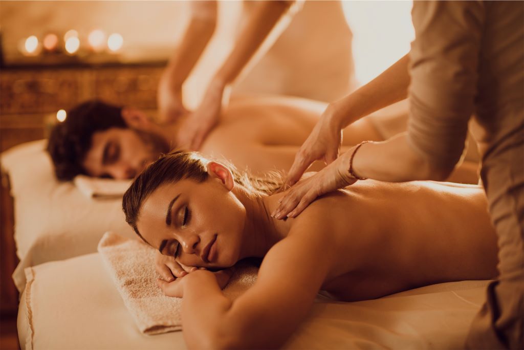 Couple enjoying relaxing massages at spa.