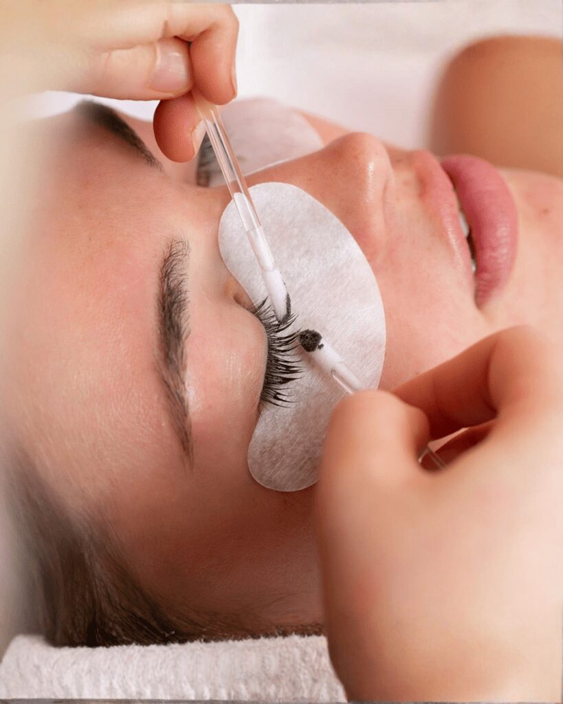 Close-up eyelash extension application on woman