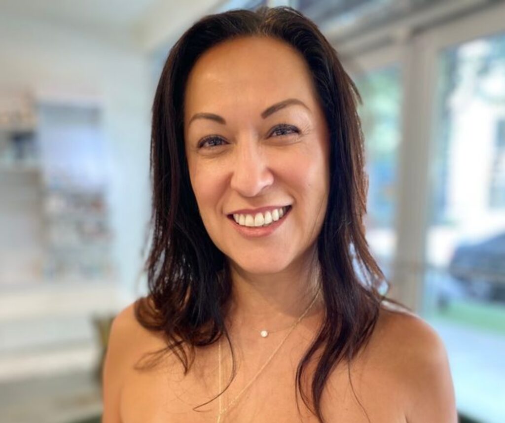 Smiling woman with dark hair indoors