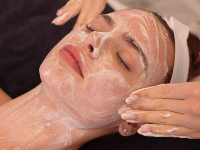 Woman receiving facial mask spa treatment