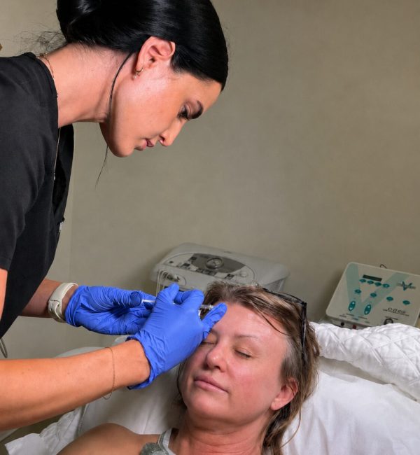 Woman receiving cosmetic forehead injection
