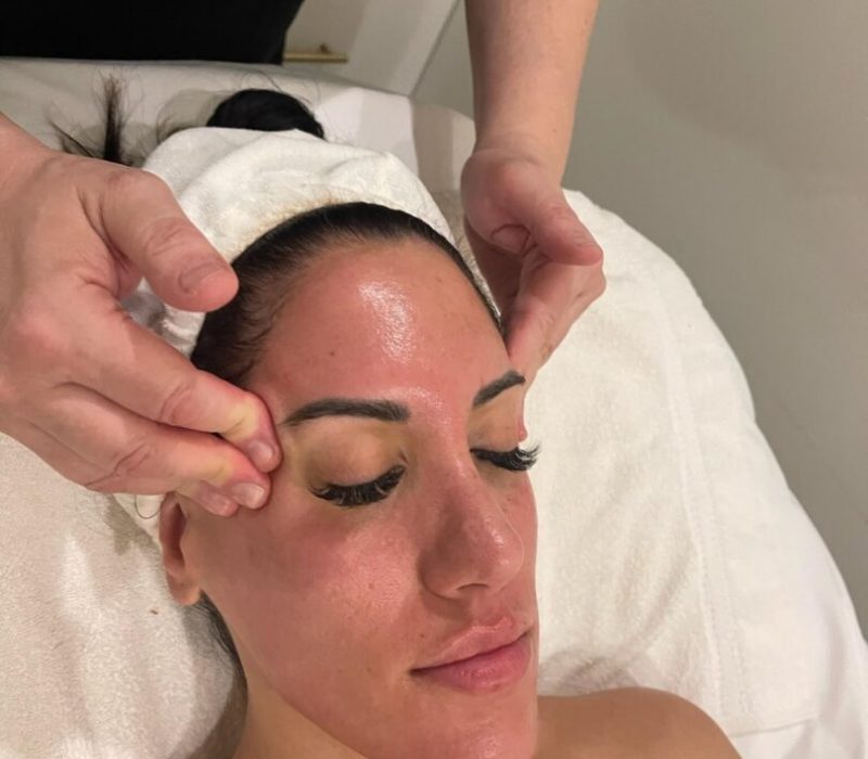 Woman receiving spa facial massage